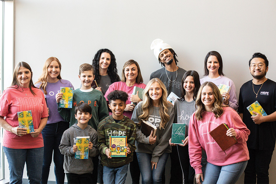 Group of people holding up Bibles